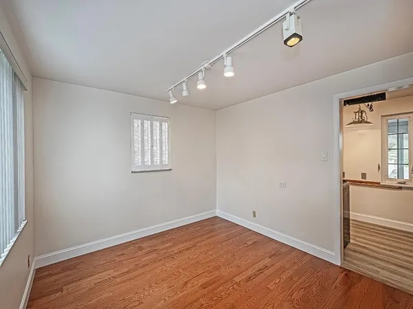a view of empty room with wooden floor