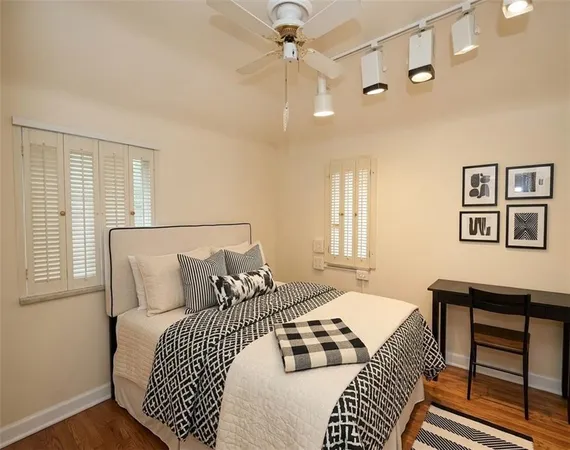 a bedroom with a bed dresser and a window