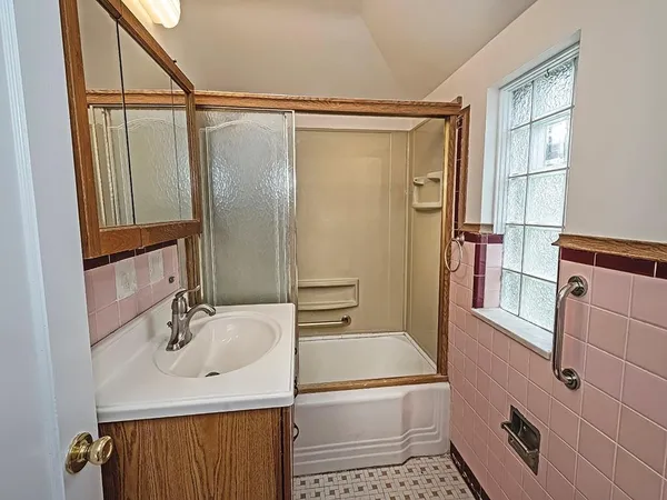a bathroom with a sink a mirror and a shower