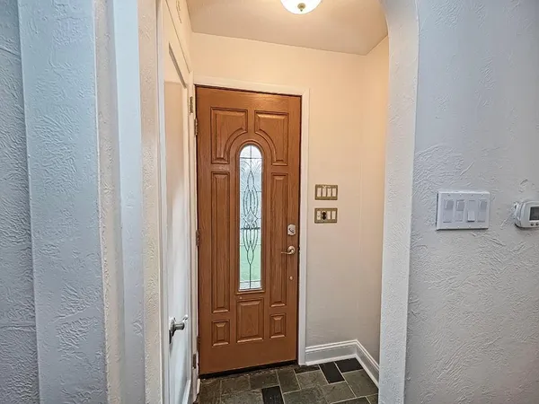 a view of front door with wooden floor