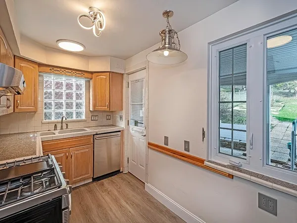 a kitchen with stove a sink and refrigerator