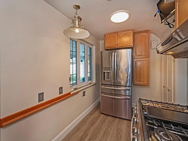 a kitchen with stainless steel appliances a refrigerator and a stove top oven