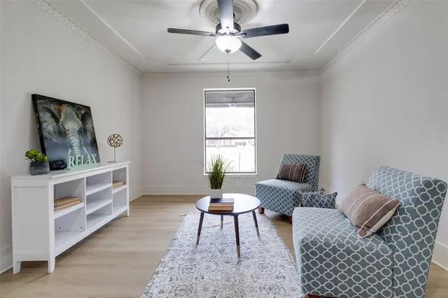 a living room with furniture a bed and a window