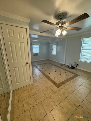 a view of a livingroom with a chandelier fan and furniture