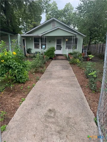 a front view of house with yard and trees