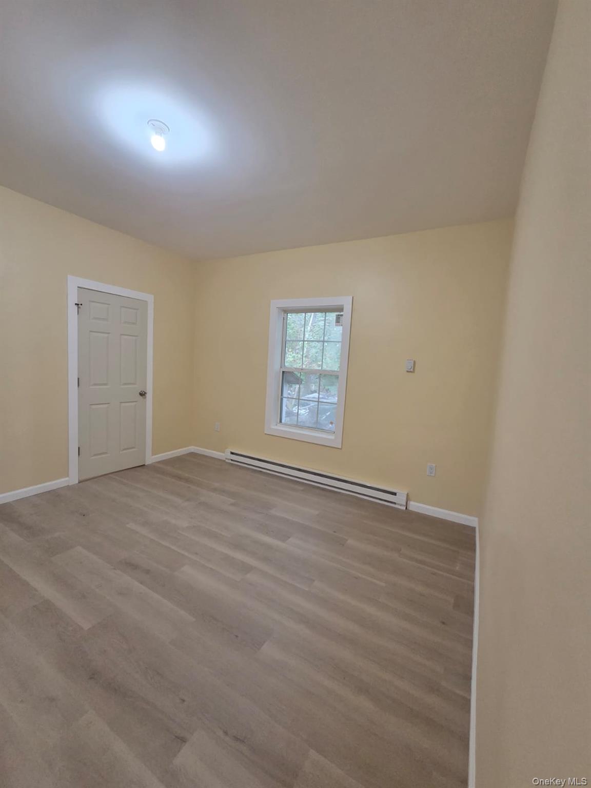 8 Cottage Street, Unit 1 Monticello, NY 12701 - Photo 3 of 9 an empty room with a window