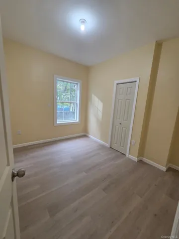 an empty room with windows and closet
