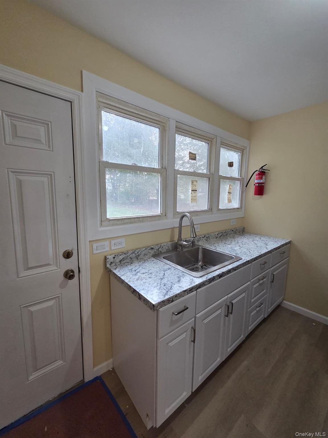 8 Cottage Street, Unit 1 Monticello, NY 12701 - Photo 8 of 9 a kitchen with sink cabinets and window