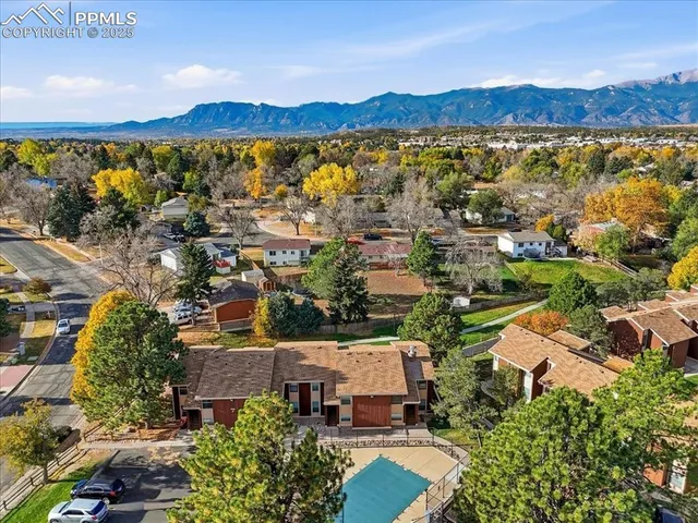 an aerial view of a house with a garden and swimming pool