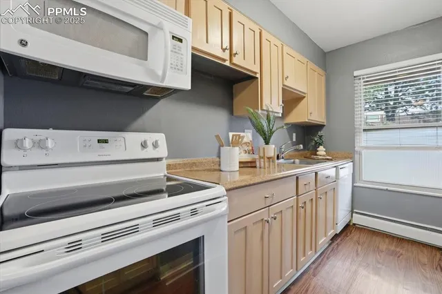 a kitchen with a stove microwave and a sink