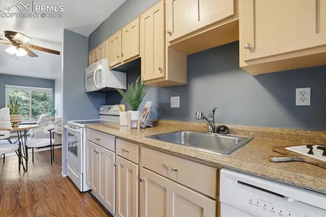 a kitchen with stainless steel appliances granite countertop a sink a stove and cabinets