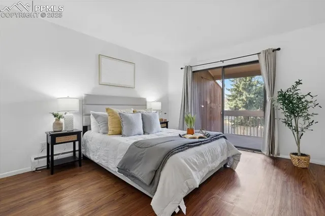 a bedroom with a bed and a large window