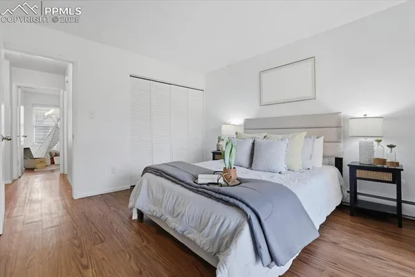 a bedroom with a bed and wooden floor