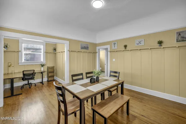 a view of a dining room with furniture and wooden floor
