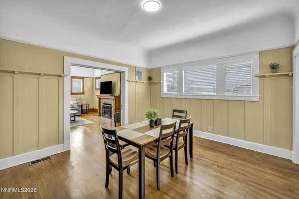 a living room with furniture and a table with wooden floor