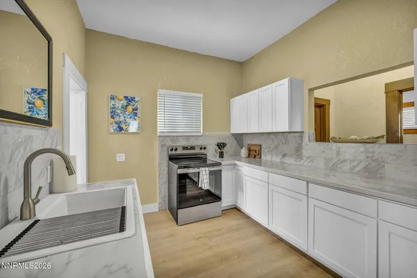 a kitchen with a refrigerator sink and cabinets
