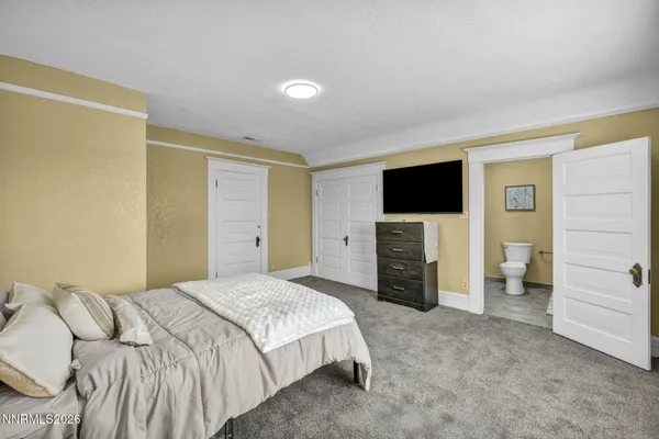 a bathroom with a granite countertop sink a mirror and a window