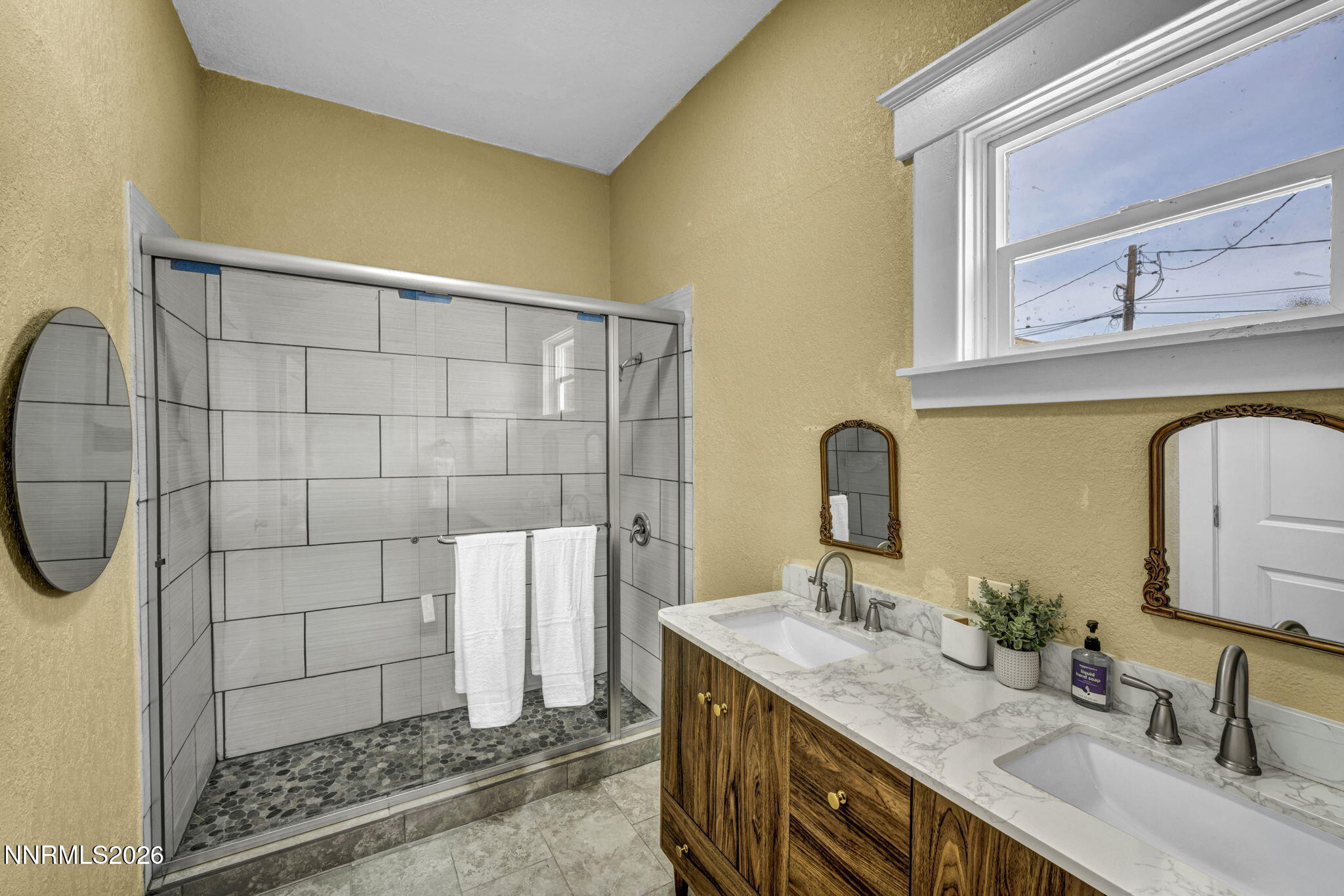 35 West 8th Street Reno, NV 89503 - Photo 26 of 62 a bathroom with a granite countertop sink a mirror and shower