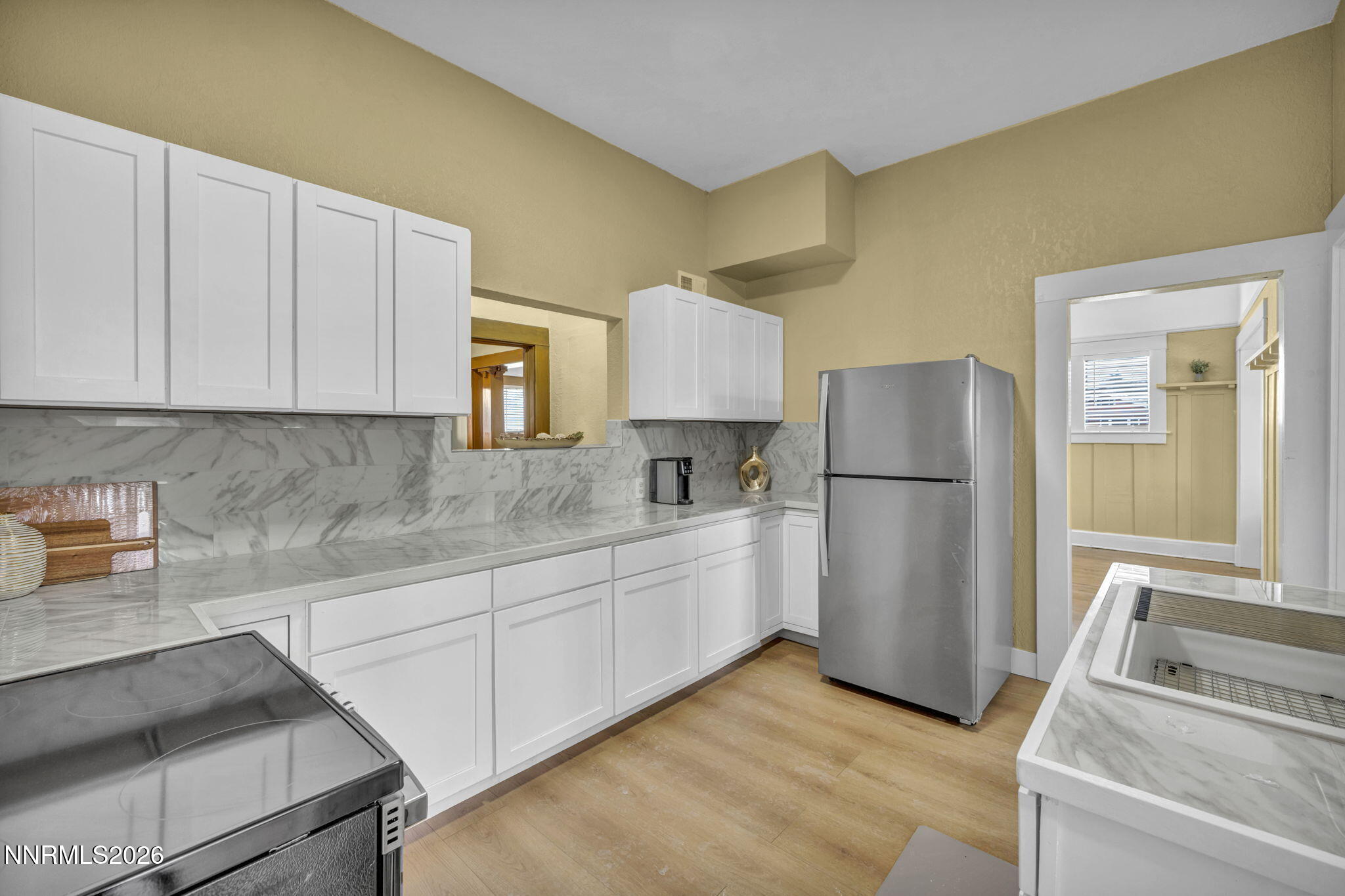 35 West 8th Street Reno, NV 89503 - Photo 3 of 62 a kitchen with a refrigerator sink and cabinets