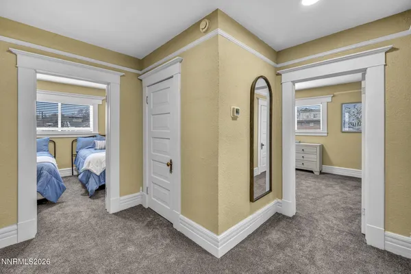 a bedroom with two beds and a window
