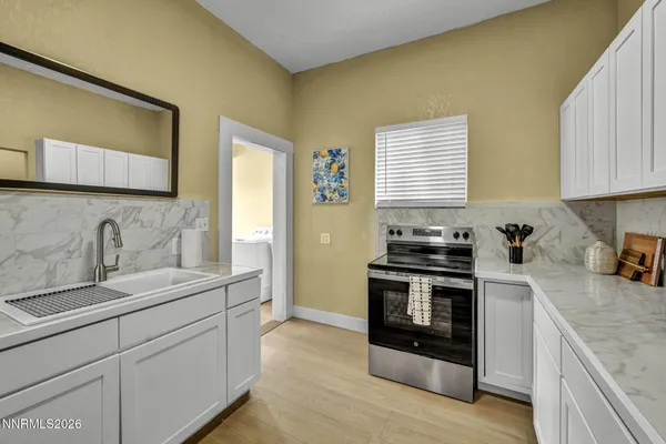 a kitchen with a stove and a white cabinet