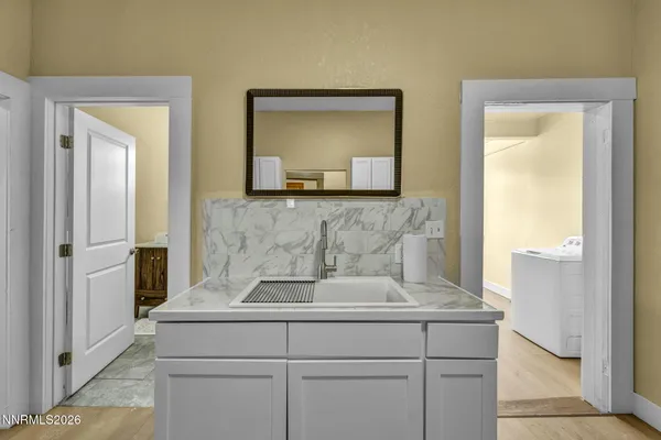 a view of kitchen with a sink and cabinets