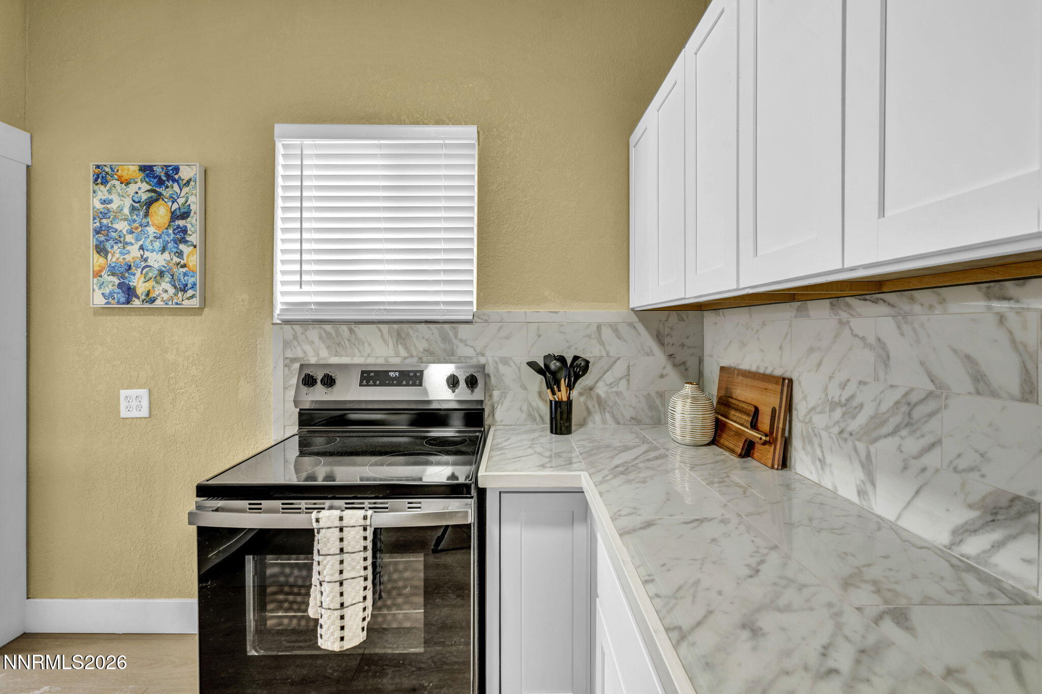 35 West 8th Street Reno, NV 89503 - Photo 7 of 62 a kitchen with a stove and a white cabinet