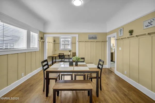 a view of a dining room with furniture and wooden floor