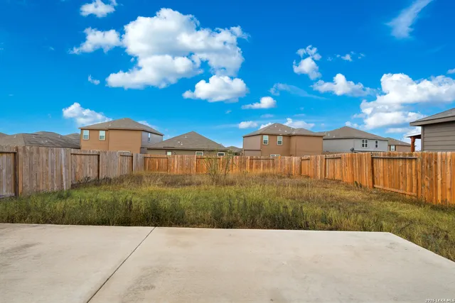 a view of a street with a view of residential houses with flower plants