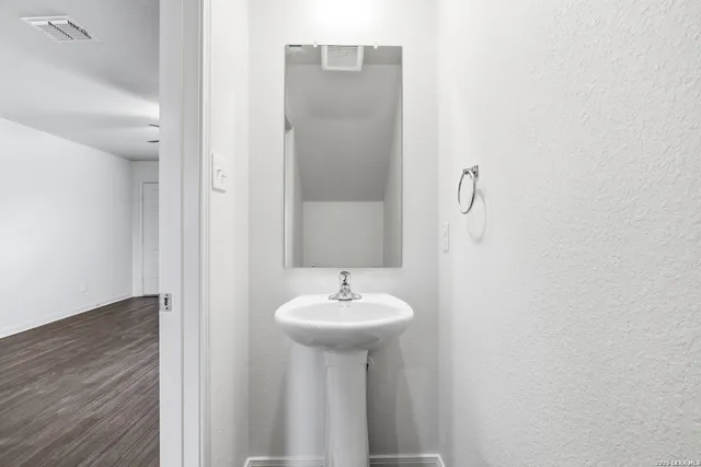 a bathroom with a sink a mirror and a