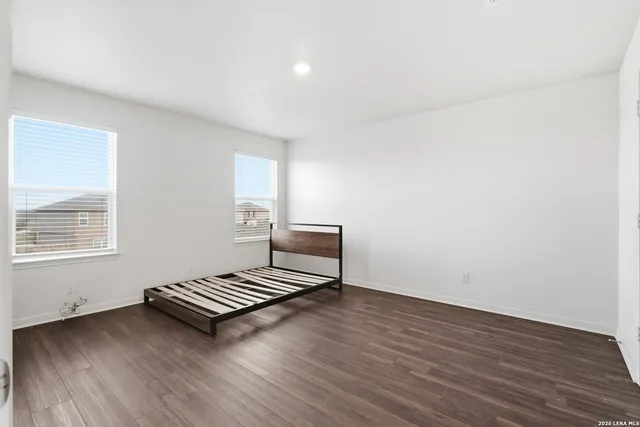 a view of wooden floor and a window in the room