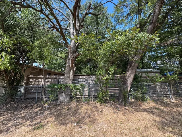 a backyard of a house with lots of trees