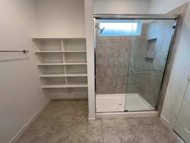 a bathroom with a glass shower door