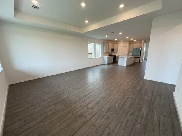 a view of a kitchen with a sink and wooden floor