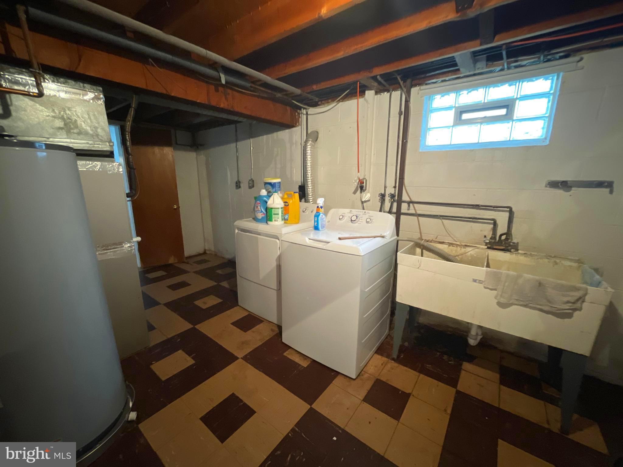 6804 Lenbern Road Baltimore, MD 21207 - Photo 16 of 17 a utility room with a sink a washer and dryer