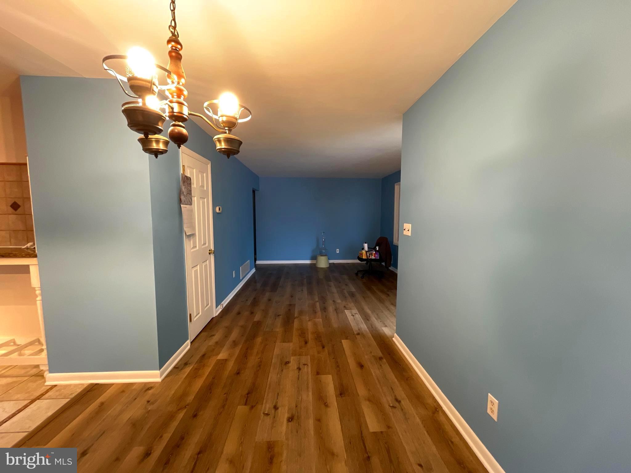 6804 Lenbern Road Baltimore, MD 21207 - Photo 5 of 17 a view of a hallway with a chandelier