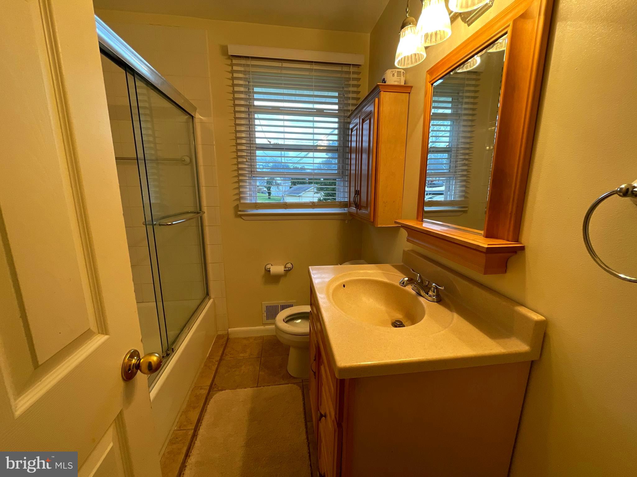 6804 Lenbern Road Baltimore, MD 21207 - Photo 7 of 17 a bathroom with a sink and a window