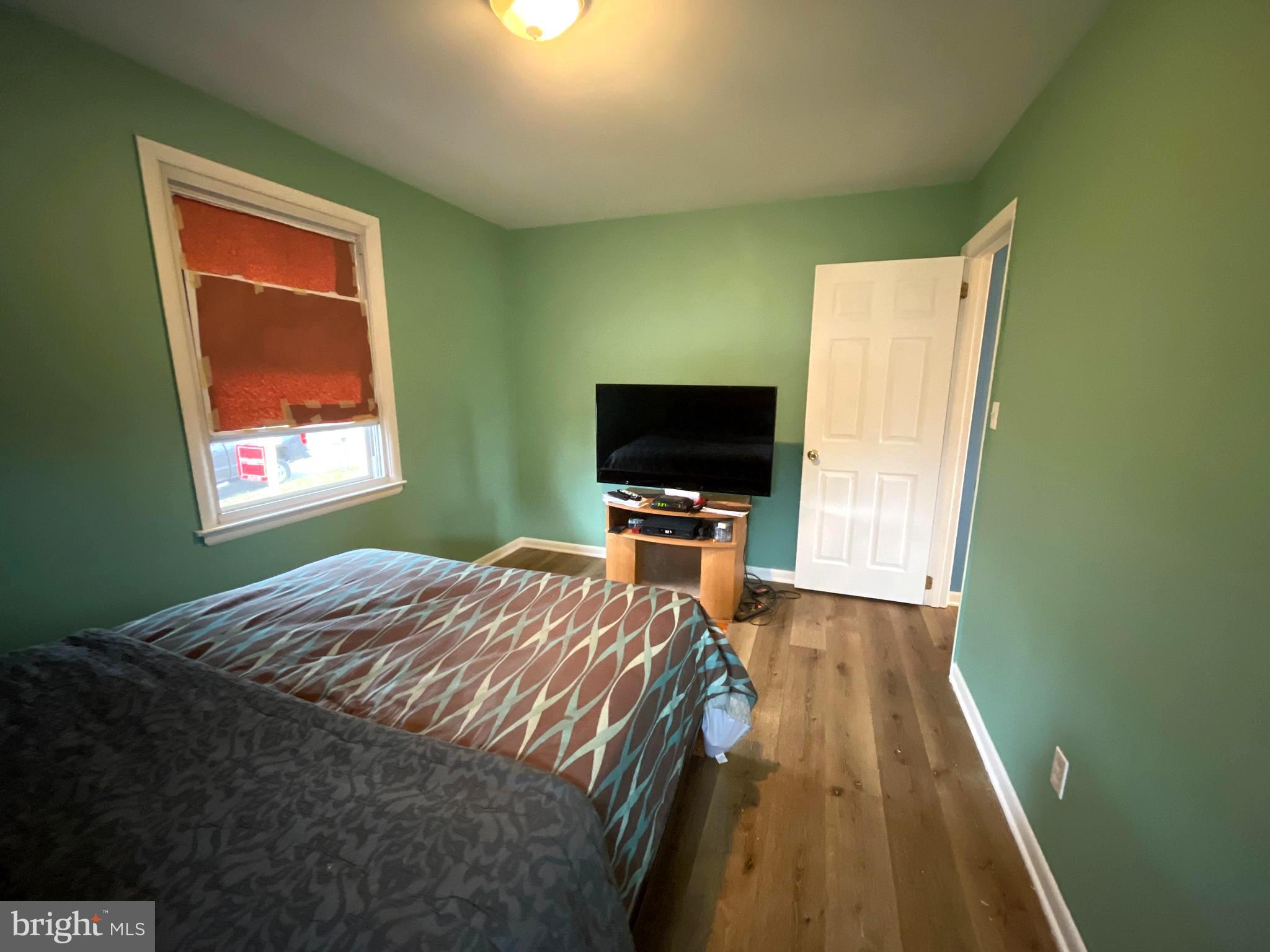 6804 Lenbern Road Baltimore, MD 21207 - Photo 10 of 17 a bedroom with a bed and a flat screen tv
