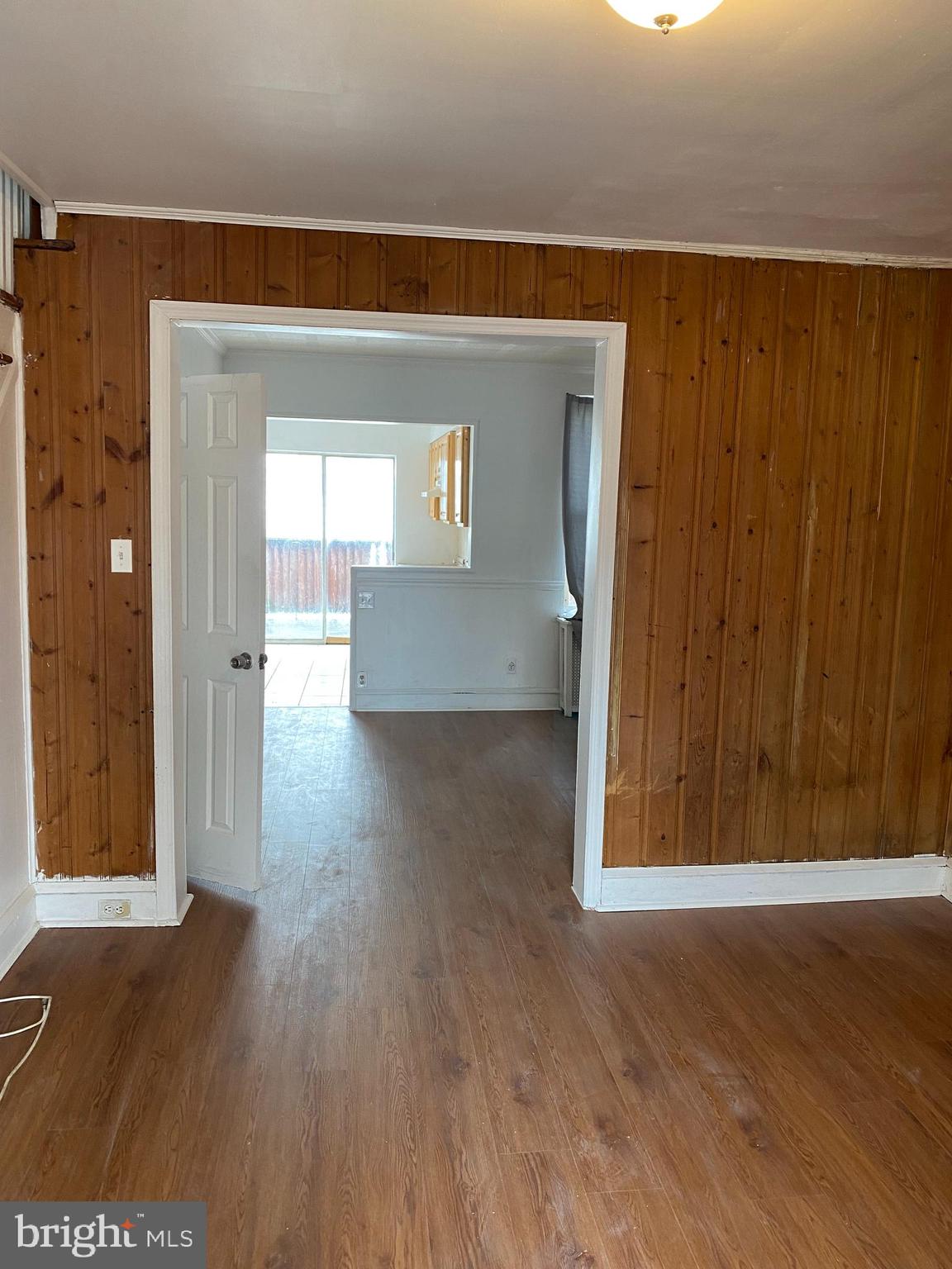 a view of a hallway with wooden floor and closet