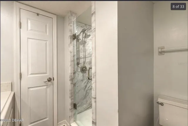 a bathroom with a glass shower door