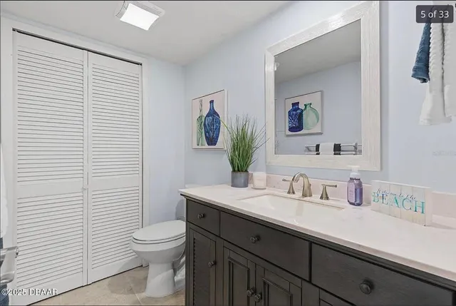 a bathroom with a sink a toilet and mirror