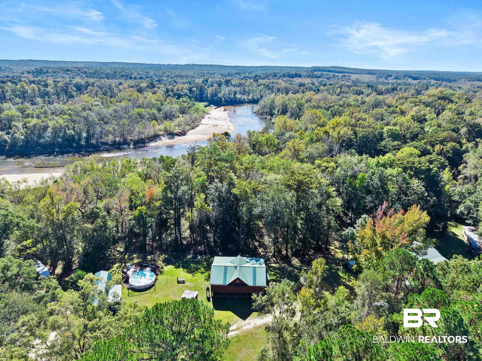 724 Rowell Lane Brewton, AL 36426 - Photo 35 of 40 Aerial view of property and surrounding area with a forest and a nearby body of water
