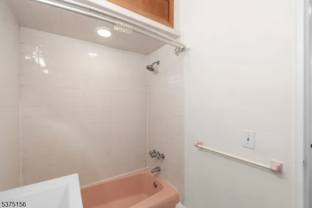 a bathroom with a tub and shower