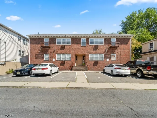 a car parked in front of a big building