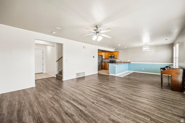 3215 West 450 North West Point, UT 84015 - Photo 4 of 40 Spacious open-concept living area featuring wood-finish flooring, a ceiling fan with integrated lighting, and neutral wall tones