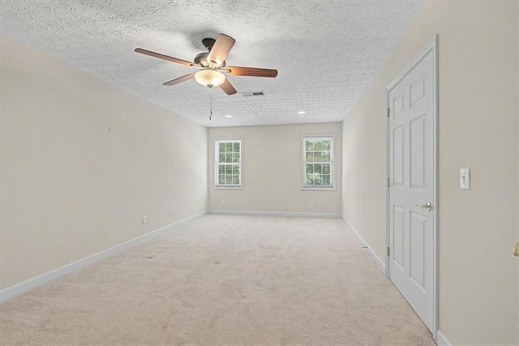 1136 Cole Lake Road Dallas, GA 30157 - Photo 45 of 72 an empty room with fan and windows