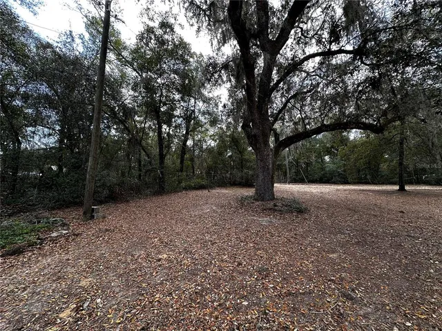 a view of balcony with wooden floor and fence