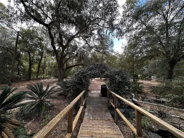 a balcony with wooden floor and fence