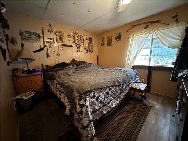 a bed sitting in a bedroom next to a window