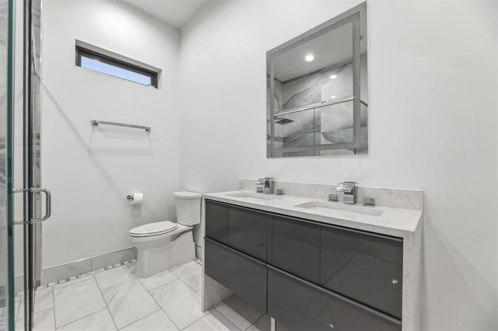 1515 North Fielder Road Arlington, TX 76012 - Photo 32 of 35 a bathroom with a toilet sink and mirror